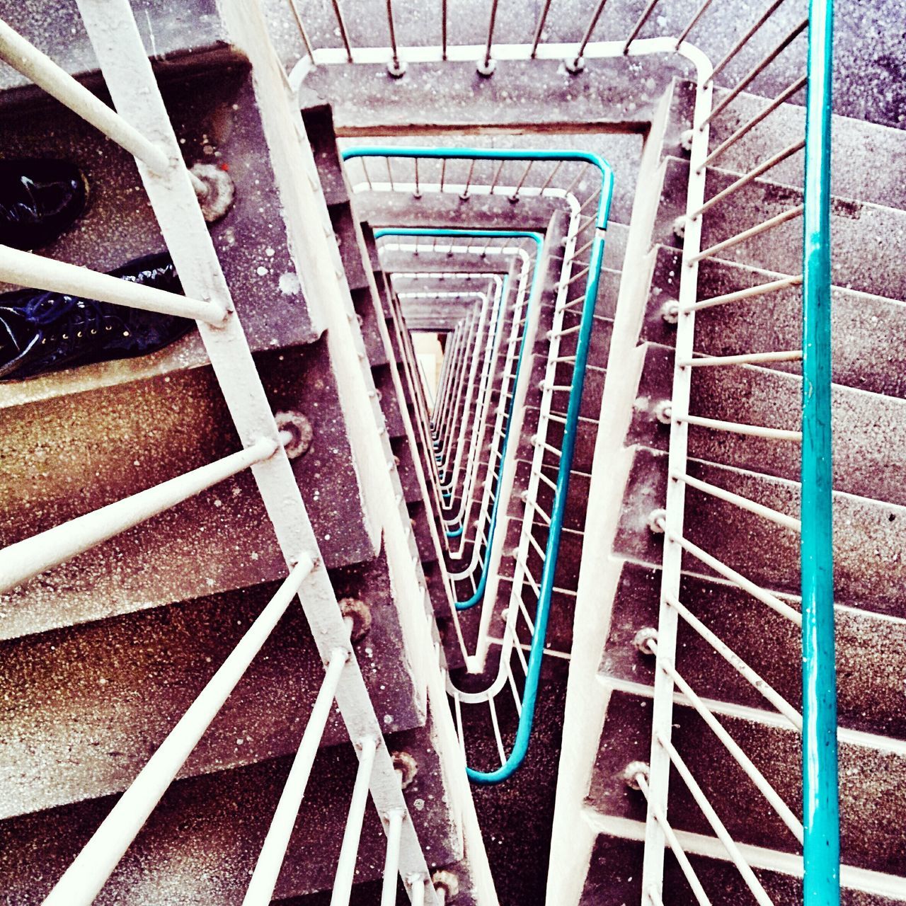 steps and staircases, steps, railing, staircase, high angle view, metal, architecture, built structure, indoors, pattern, stairs, escalator, sunlight, spiral staircase, metallic, no people, spiral, day, low angle view, building