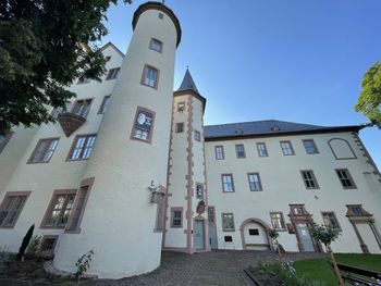 Exterior of buildings in town against clear blue sky