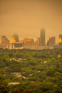 Buildings in city against sky during sunset