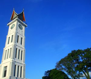 Low angle view of building against clear blue sky