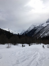 Scenic view of snow covered mountains against sky