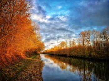 Scenic view of lake by trees against sky during autumn