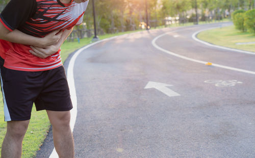 Rear view of man standing on road