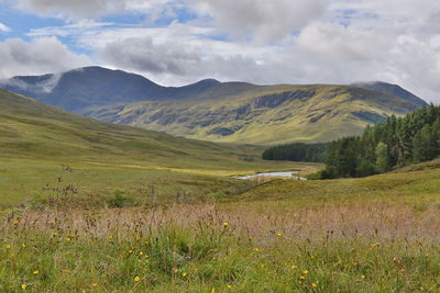 Scenic view of mountains against cloudy sky