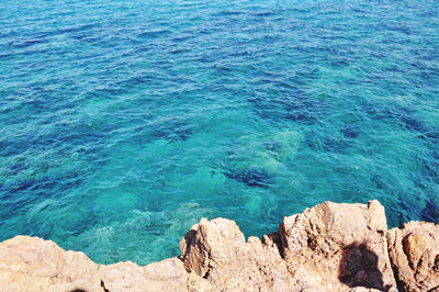 High angle view of rocks by sea