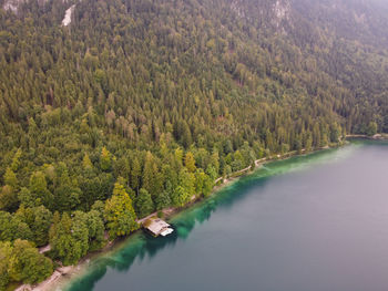 German wooden summer house overlooking scenic lake at mountains. bavarian alps.