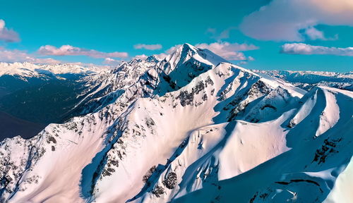 Scenic view of snowcapped mountains against sky