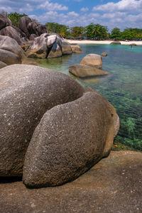 Rocks on beach against sky