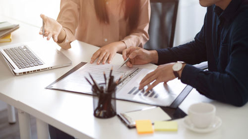 Midsection of man working at office