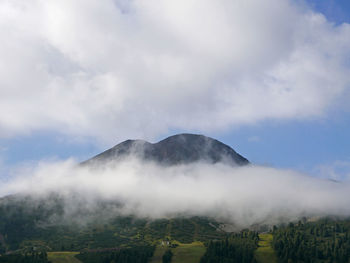 Evocative image of a mountain peak shrouded in fog