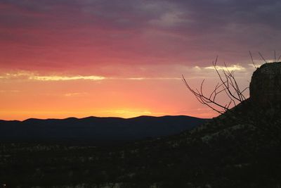 Silhouette of landscape against sky at sunset