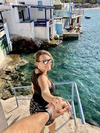 Portrait of smiling woman sitting in water