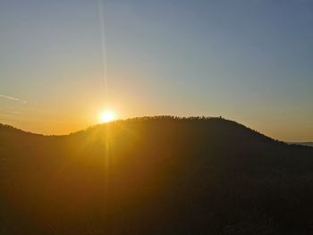 Scenic view of silhouette mountains against sky during sunset