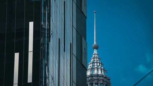 Low angle view of modern building against blue sky