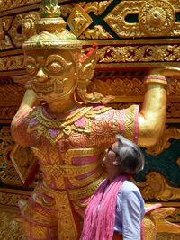 Rear view of woman statue at temple