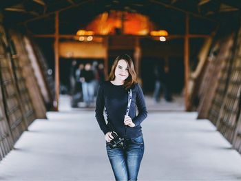 Portrait of young woman standing outdoors