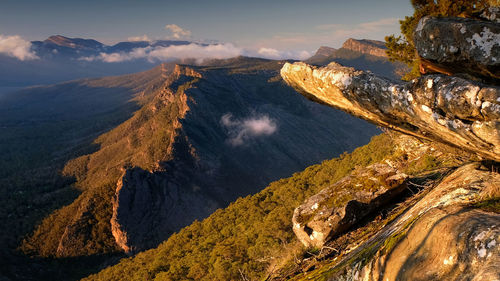 Mountain range and close up rocks at sunrise with clouds at the grampians