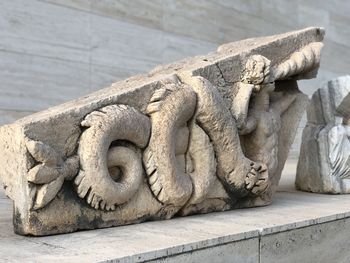 Close-up of statue against stone wall