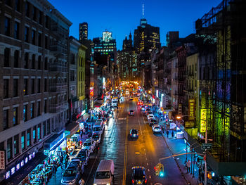 High angle view of city lit up at night