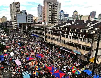 Crowd in city against sky