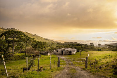 Built structure on land against sky during sunset