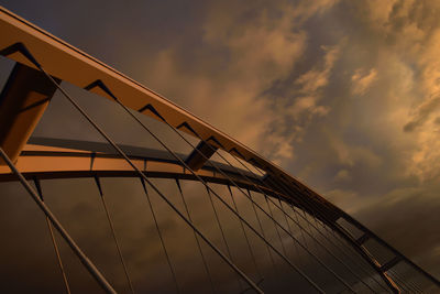 Low angle view of suspension bridge against sky