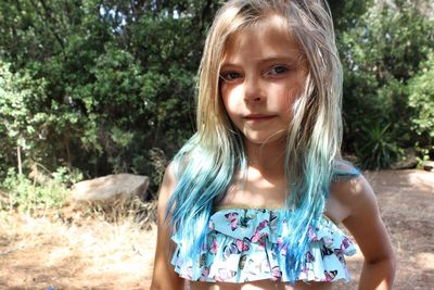 Portrait of girl with dyed hair standing at park