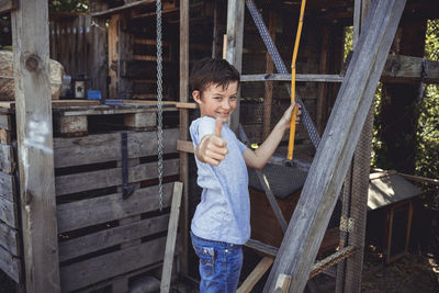 Full length of a boy holding wood