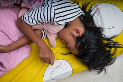 High angle view of baby sleeping on bed at home