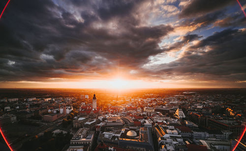 High angle view of city buildings against sky during sunset