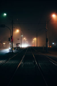 View of illuminated railroad tracks at night