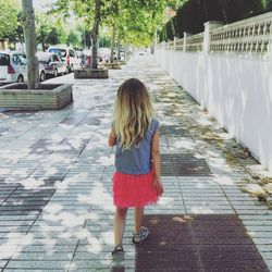 Woman standing on footpath