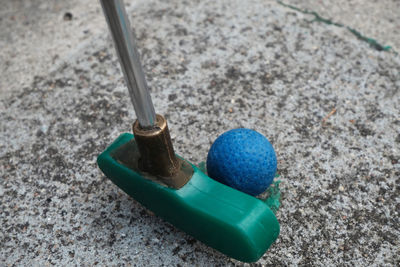 High angle view of minigolf club hitting ball