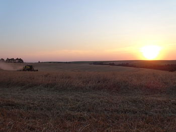 Scenic view of land against sky during sunset