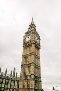 Low angle view of clock tower against sky