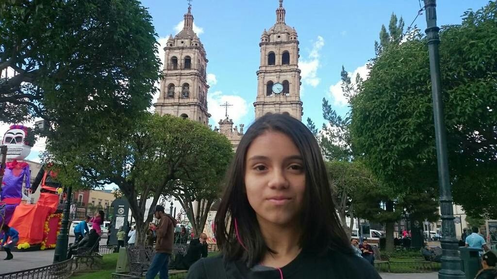 PORTRAIT OF WOMAN AGAINST CATHEDRAL