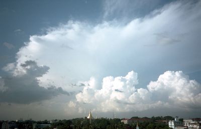 Cityscape against cloudy sky