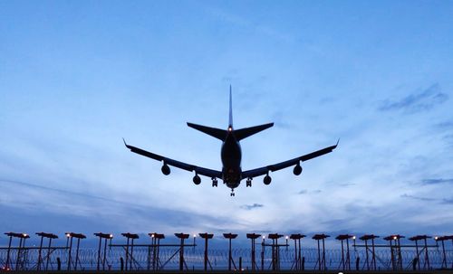 Low angle view of airplane flying against sky