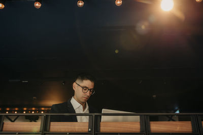 Businessman wearing eyeglasses using laptop in hotel