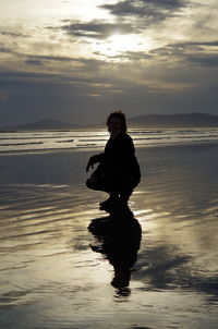 Full length of man on beach during sunset