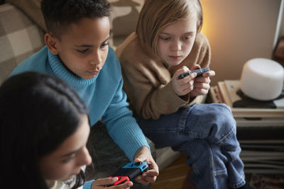 Children playing video games at home