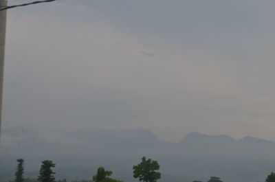 Scenic view of silhouette mountains against sky at sunset