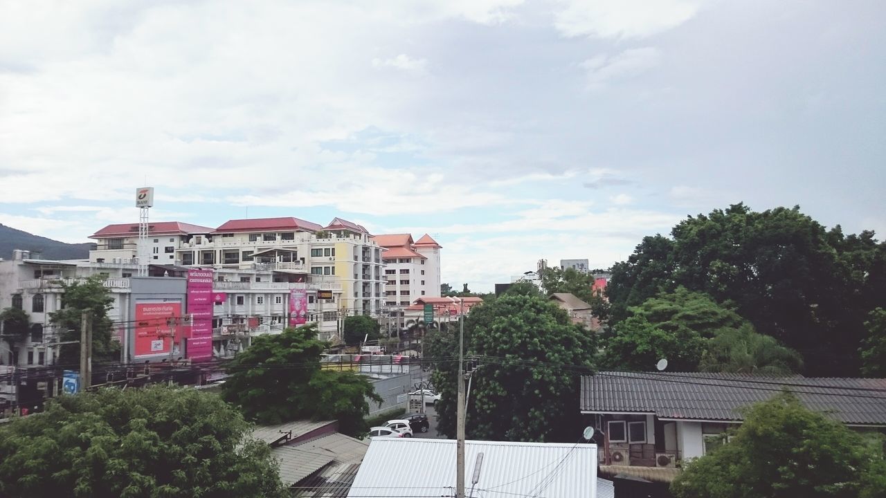 building exterior, architecture, built structure, tree, sky, residential structure, residential building, house, city, residential district, roof, building, day, outdoors, town, street, city life, cloud, cloud - sky, sunlight