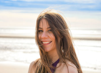 Portrait of smiling young woman at beach