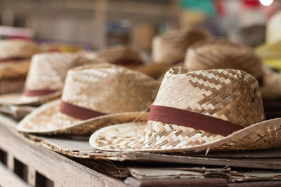 Close-up of straw hats at market stall