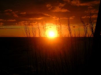 Scenic view of silhouette landscape against romantic sky at sunset