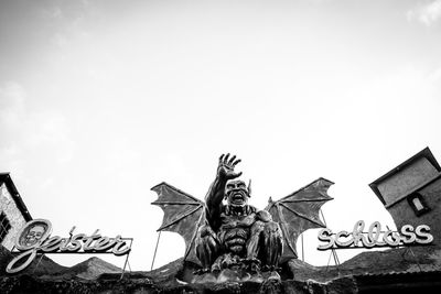 Low angle view of angel statue against sky