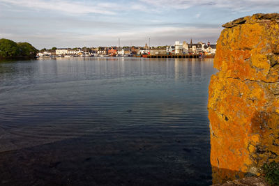 Scenic view of sea by buildings against sky