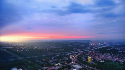 High angle view of illuminated buildings against sky at sunset