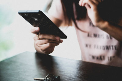 Midsection of man using mobile phone